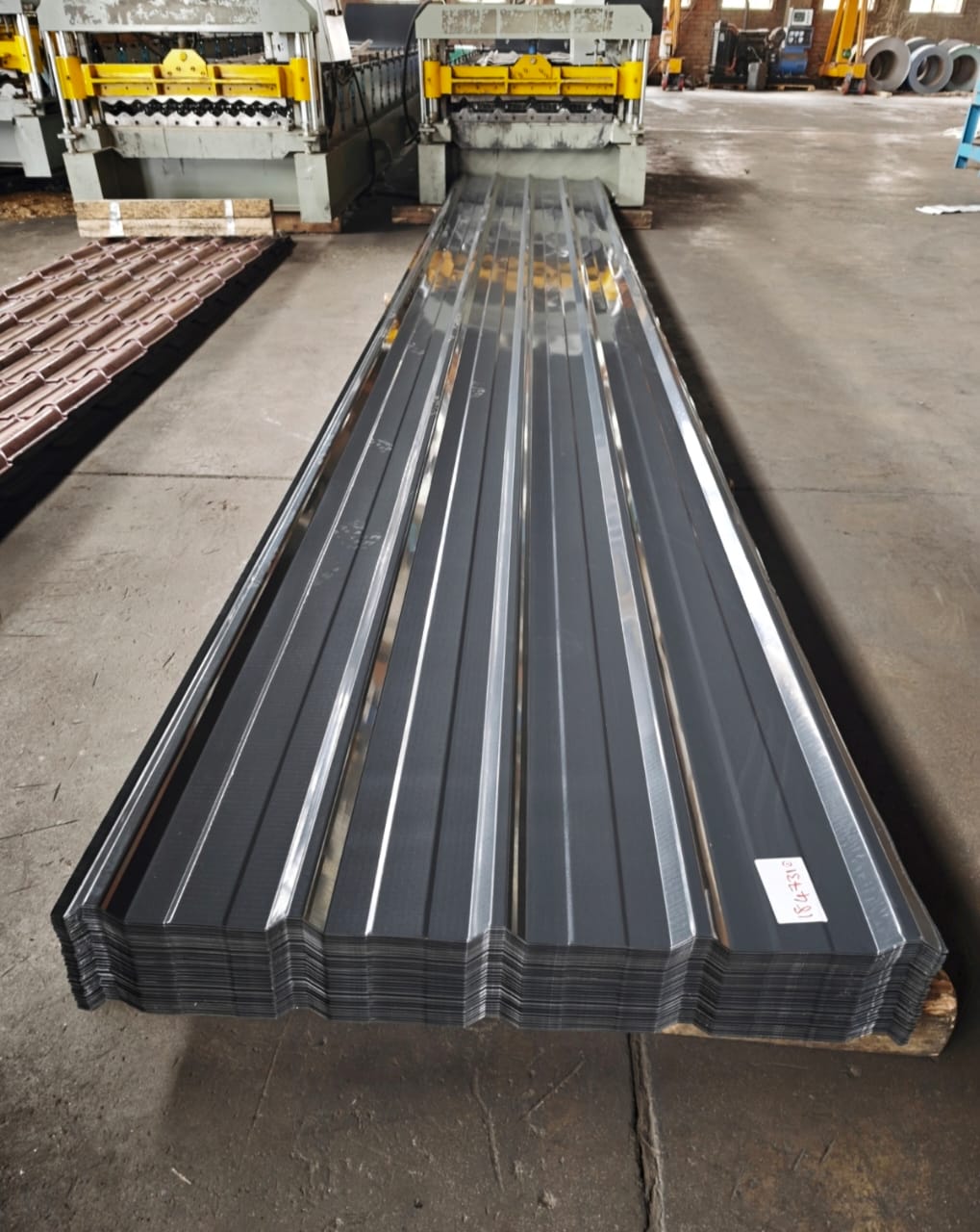 Grey Chromadek roofing sheets stacked in warehouse